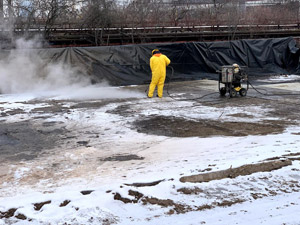 December 2019 - View looking north: Decontamination of mats on the metal wash pad.