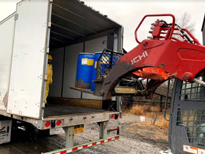 December 2019 - View looking west: Drums filled with mixed waste (asbestos and K142) loaded for disposal transport.