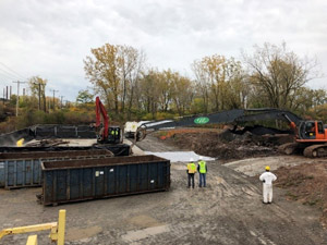 October 2019 - Site 108 - view looking northeast. Steel removed during tank demolition was stockpiled adjacent to Tank 3 within the berm area. Steel was picked up by the grapple and transferred to the decontamination pad for hot water high pressure cleaning.